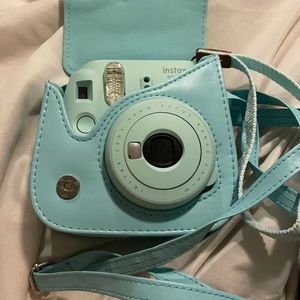 Blue Polaroid camera with case